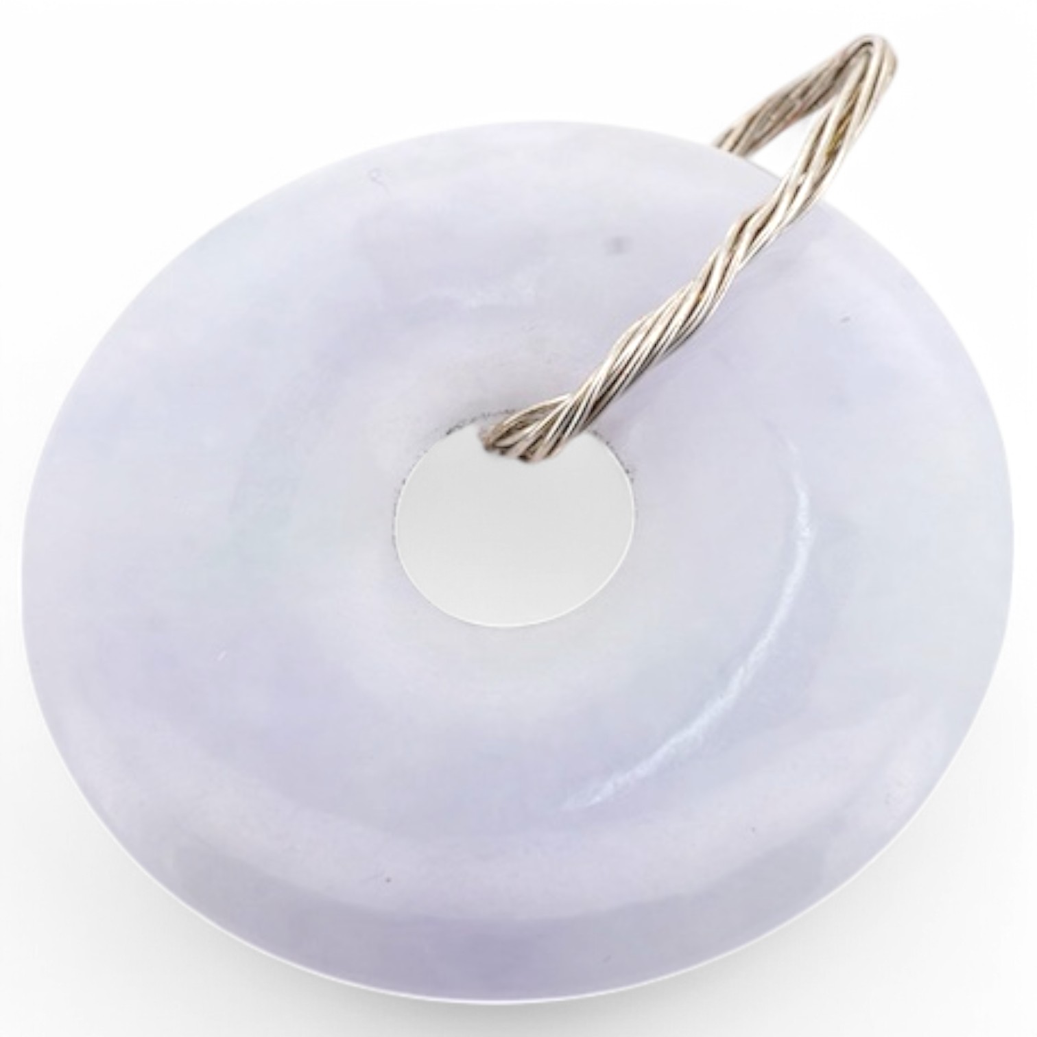 A jadeite pendant, designed as a disc of mottled white/pale lavender jadeite, to a bail of coiled wire, length 4.5cm, gross weight 12 grams, Condition: good